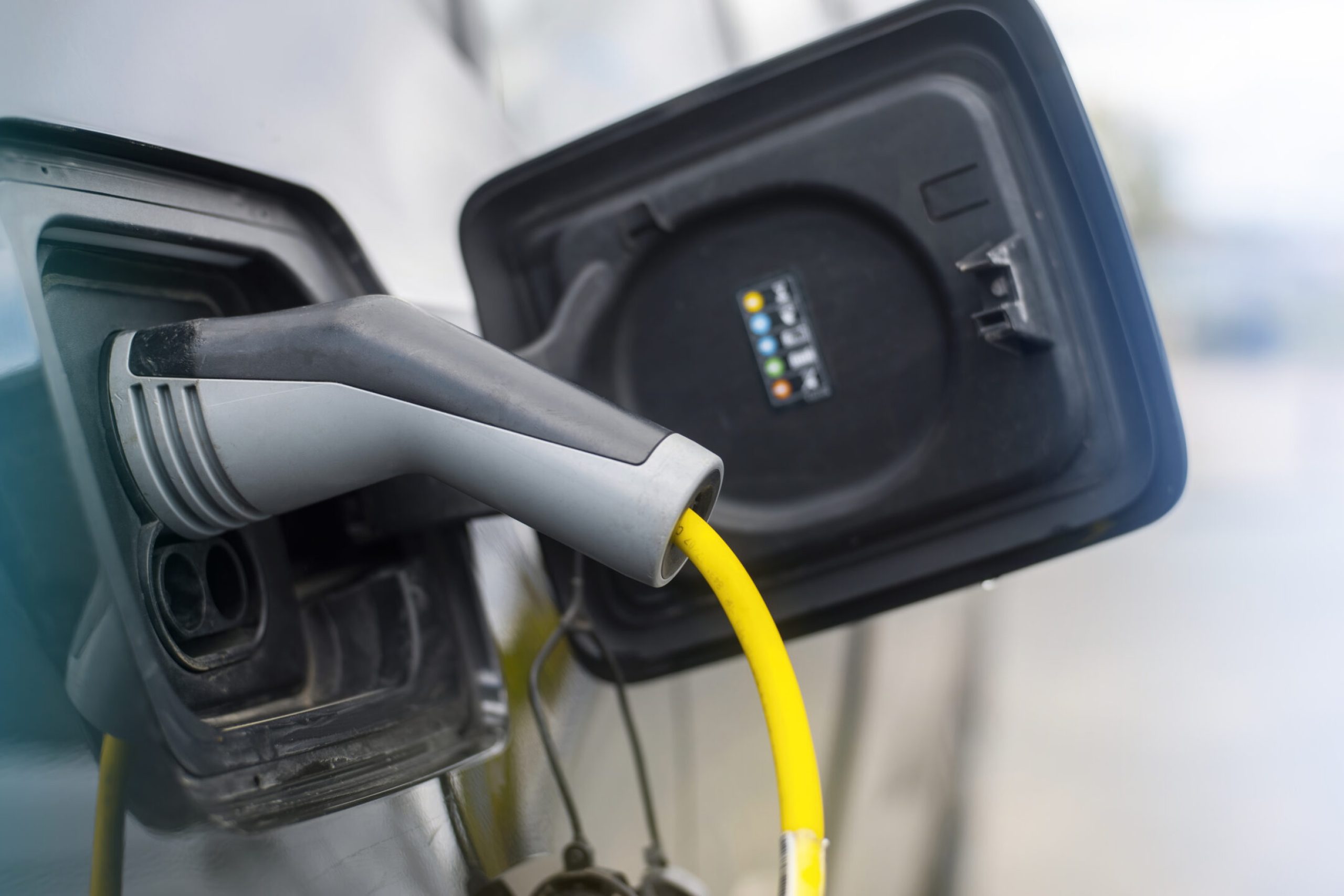 Plugged in charger into an electric car at charge station